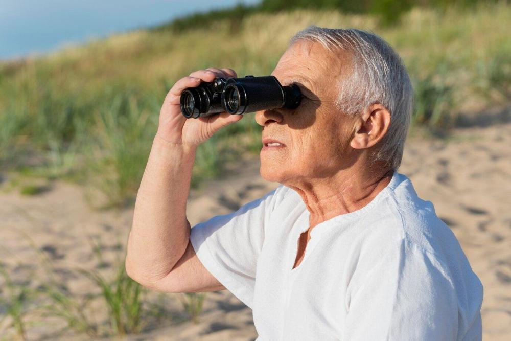 side-view-older-man-with-binoculars-outdoors_23-2148642011.jpg